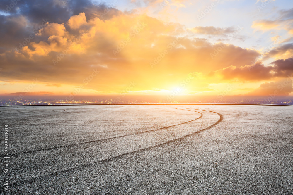 Empty asphalt square ground and city skyline with beautiful clouds at sunset