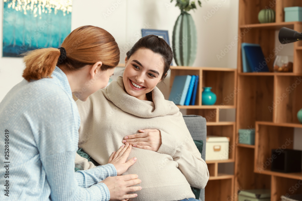 Doula with pregnant woman at home