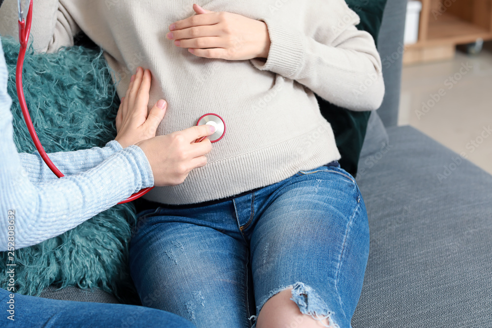 Doula with pregnant woman at home