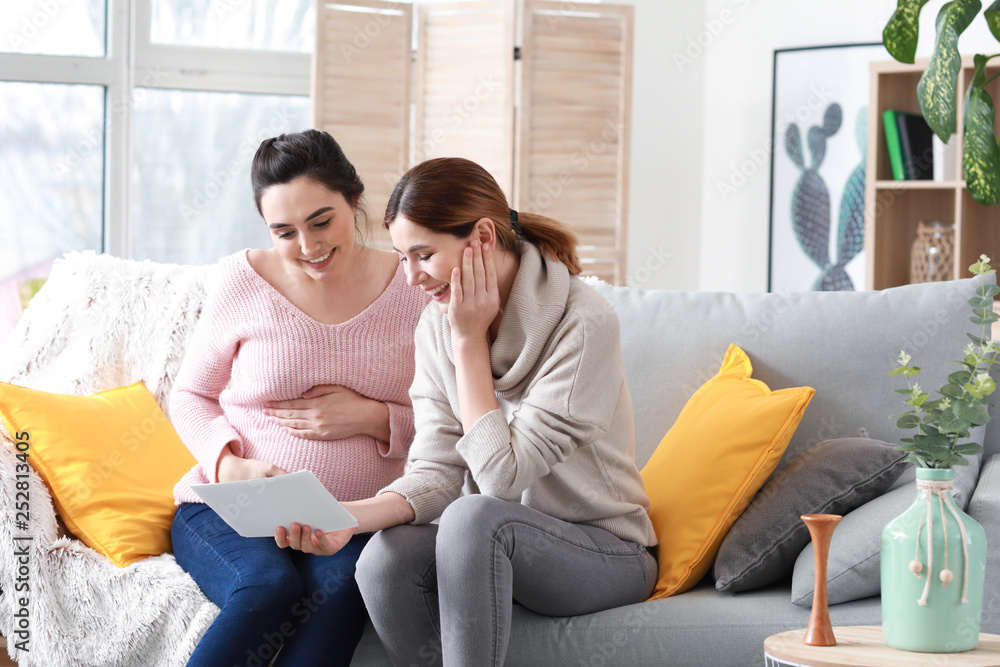 Doula and pregnant woman with ultrasound scans at home