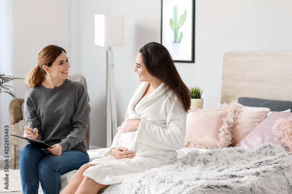 Doula with pregnant woman at home