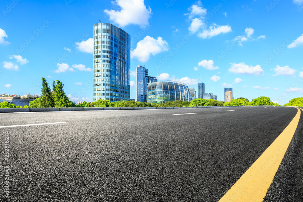 Empty asphalt road and modern commercial buildings in Shanghai