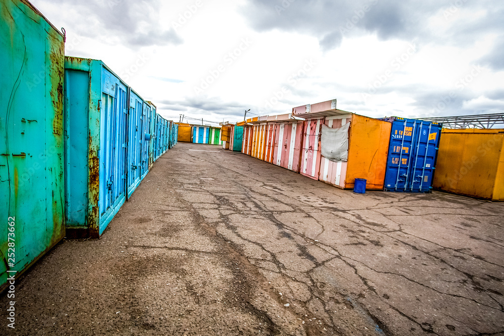 multicolored garages in the industrial area witn asphalt road