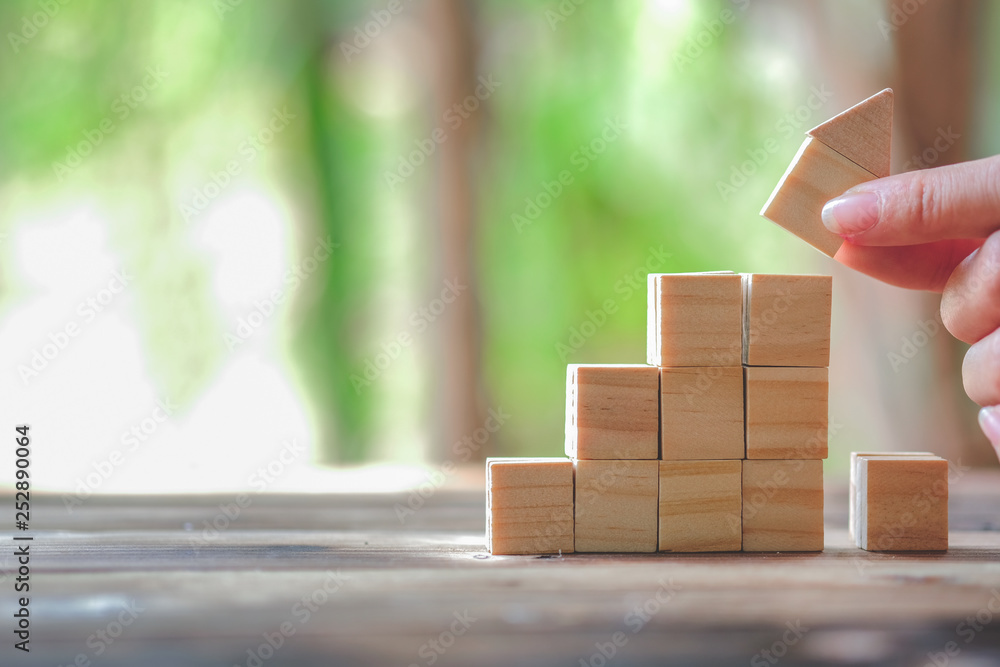 Wood block stacking as step stair and coins stacked, business growth to success.Startup concepts wit