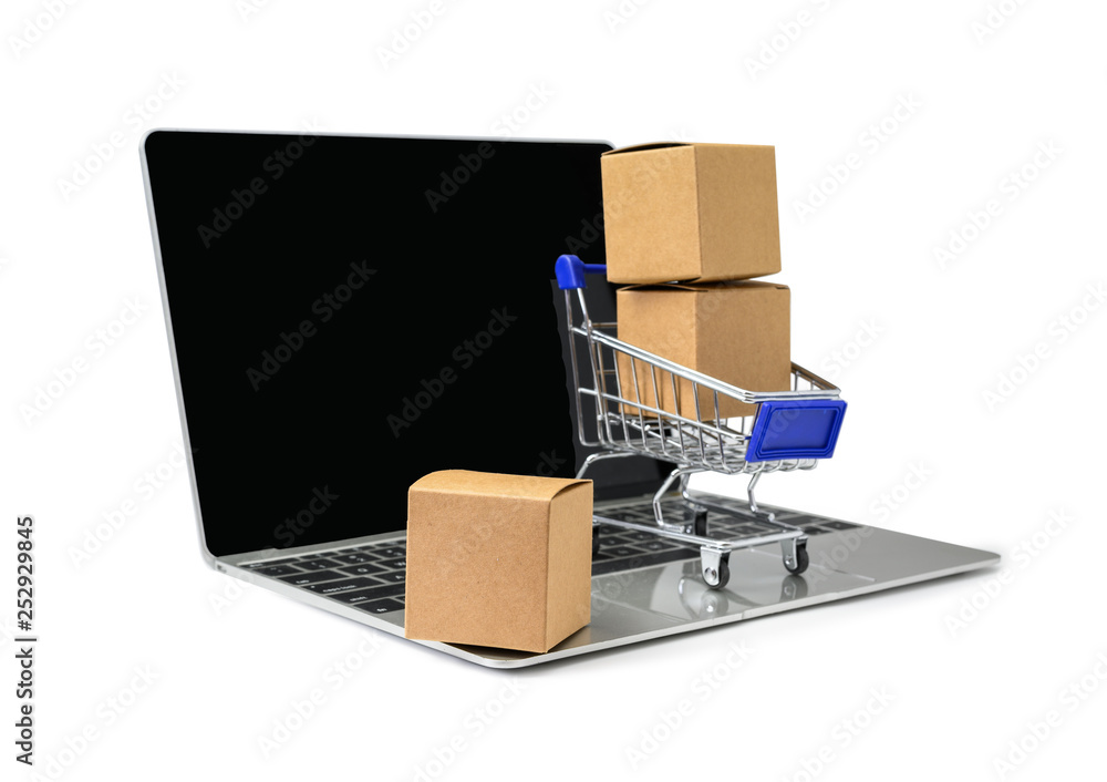 Boxes in a trolley on a laptop keyboard on white  background with clipping path. Concepts about onli