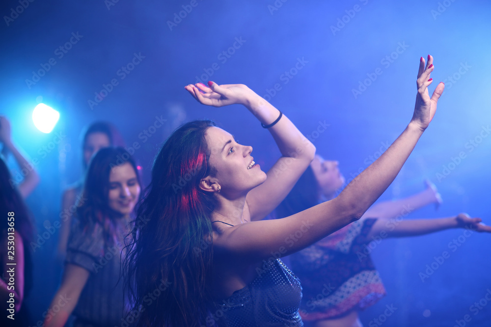 Beautiful young women dancing in night club