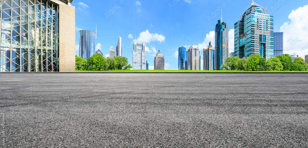 Asphalt road ground and modern city commercial building scenery in Shanghai