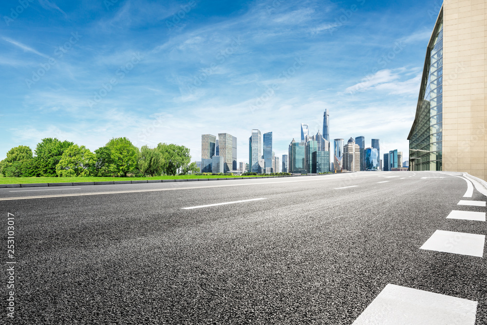 Asphalt road and modern city commercial building scenery in Shanghai