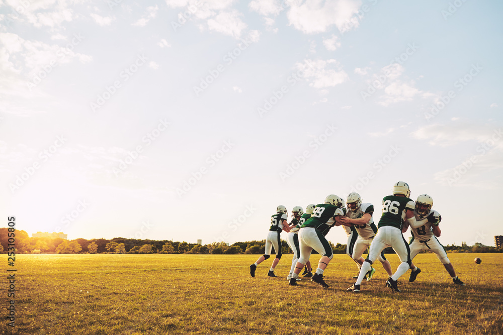 American football team doing defensive drills during a practice