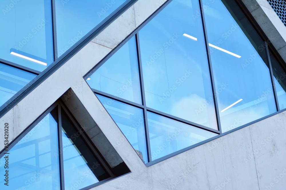 Abstract image of looking up at modern glass and concrete building. Architectural exterior detail of