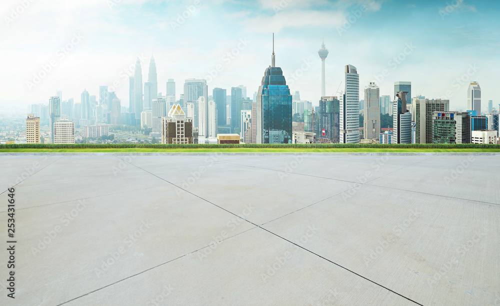 Empty concrete cement floor with green and cityscape skyline , morning scene .