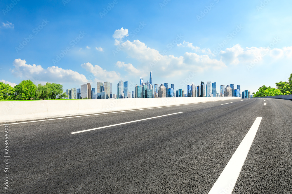 Empty asphalt road and panoramic city skyline with buildings in Shanghai