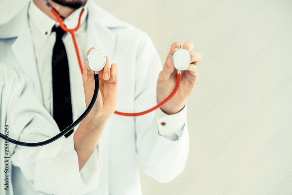 Close up shot of two doctors pointing stethoscope at copy space. Selective focus at front doctors ha