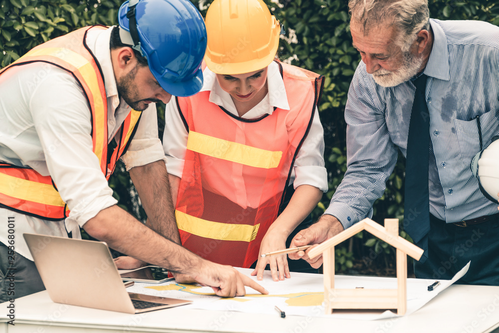 Engineer, architect and business man working on the engineering project at construction site. House 