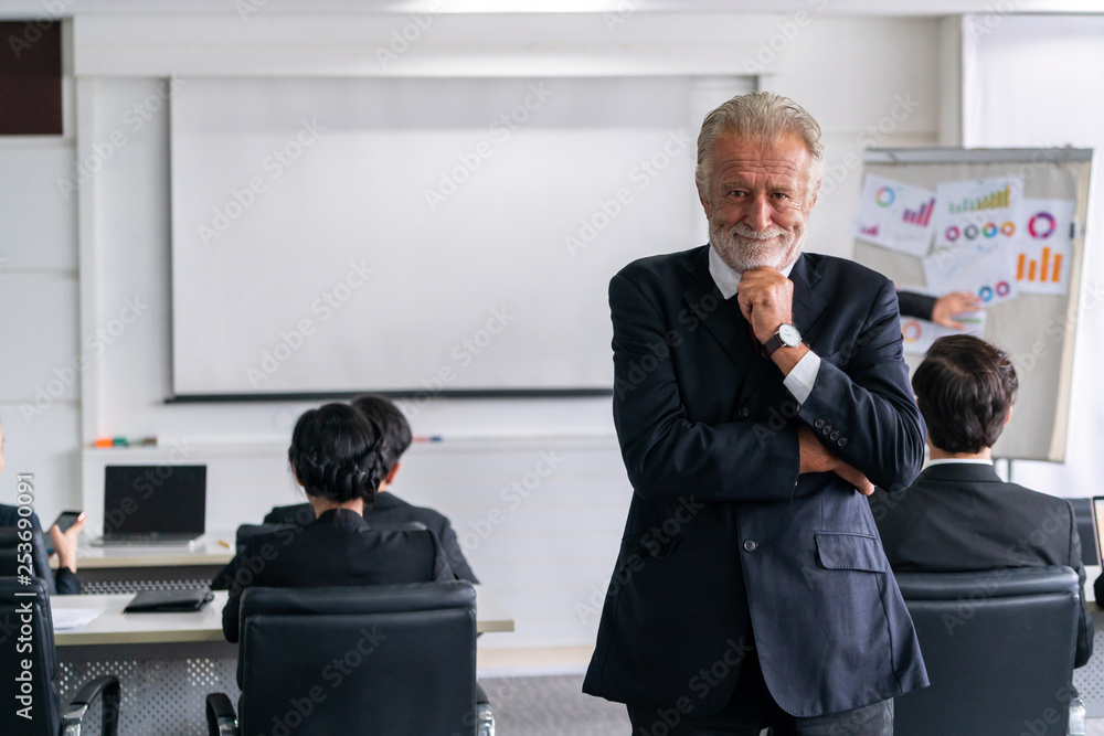 Senior executive CEO manager standing in front of team members Business leadership concept.