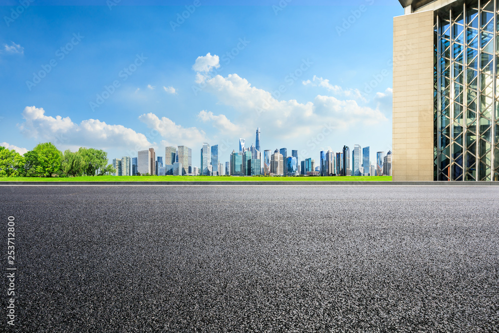 Empty asphalt road and panoramic city skyline with buildings in Shanghai