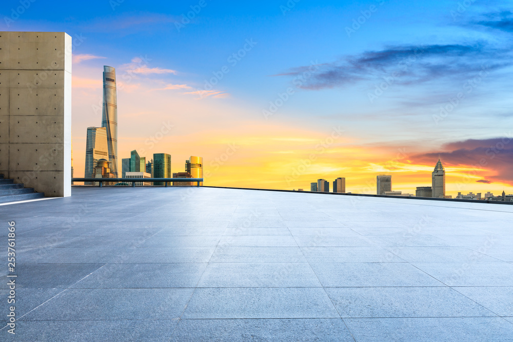 Empty square floor and modern city buildings in Shanghai at dusk