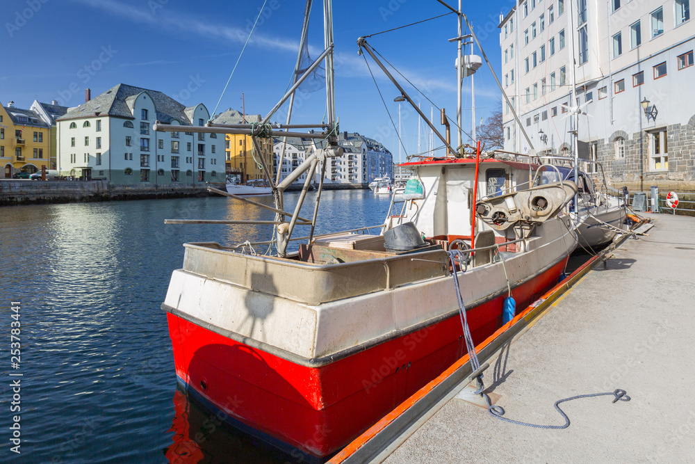 Fishing boats in the harbor of Alesund town, Norway