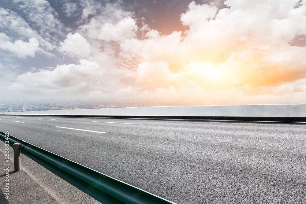 Asphalt highway passing above modern city