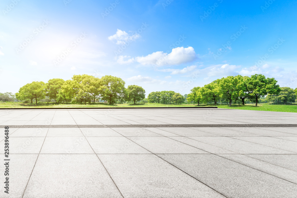 Empty square floor and green forest in the city park