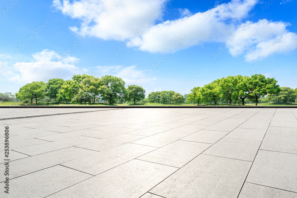 Empty square floor and green forest in the city park