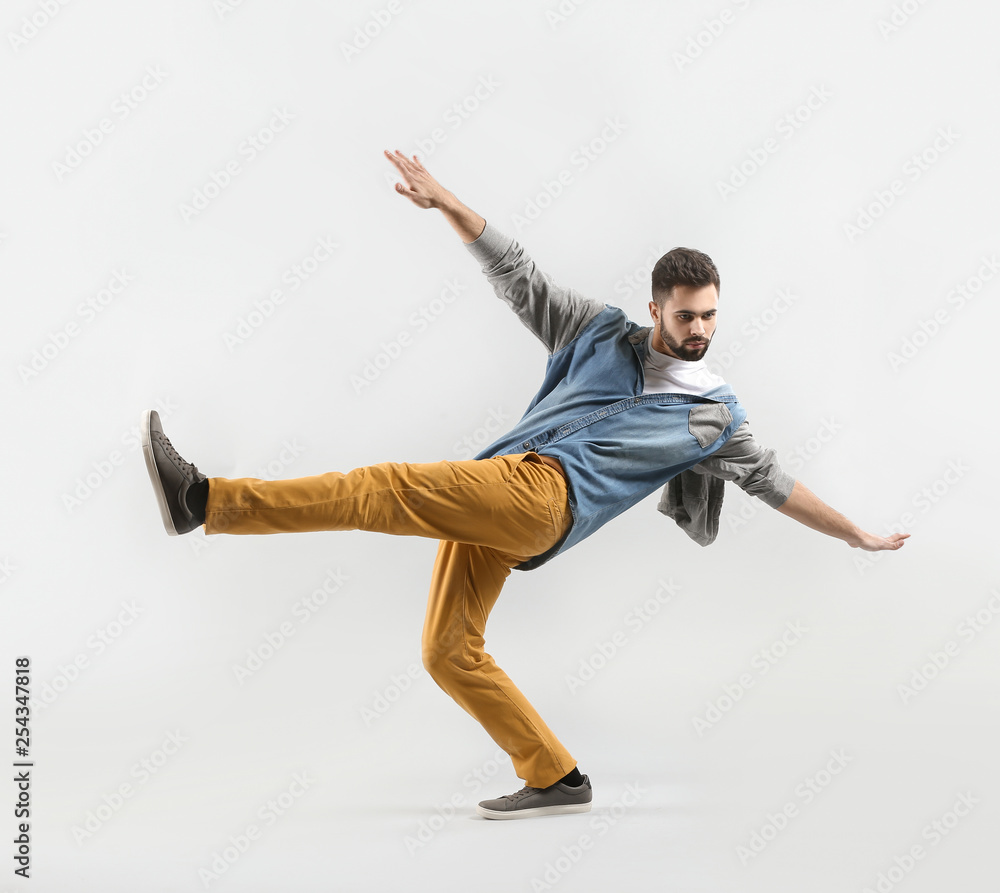 Fashionable young man on light background