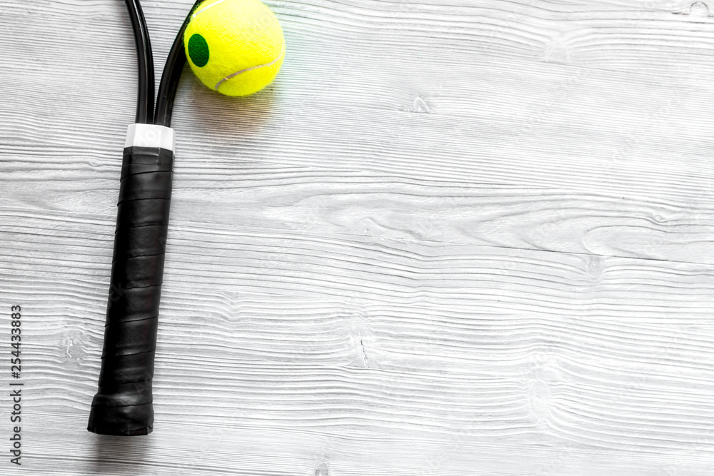 tennis racket on wooden background top view