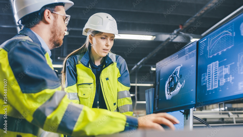 At the Factory: Male Mechanical Engineer and Female Chief Engineer Work Together on the Personal Com