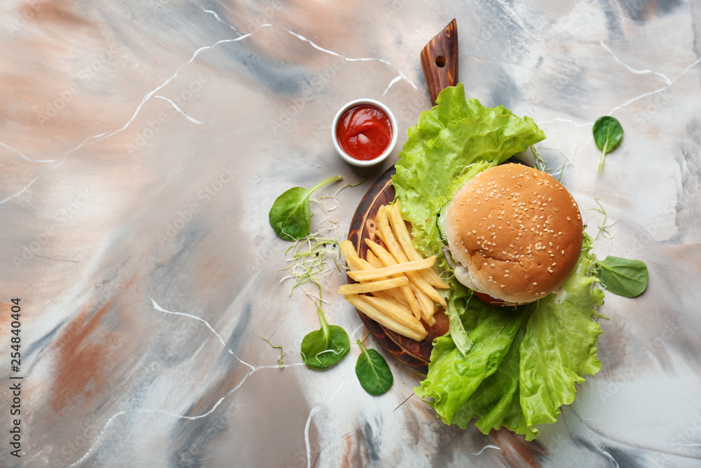 Tasty burger and french fries on table