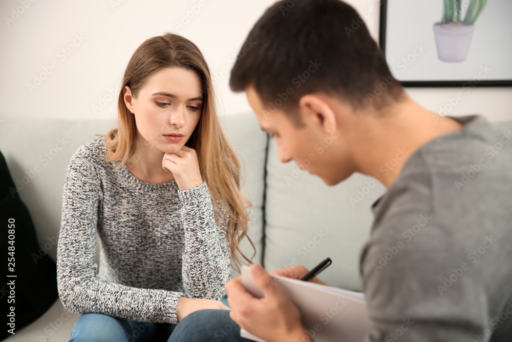 Male psychologist working with patient in office