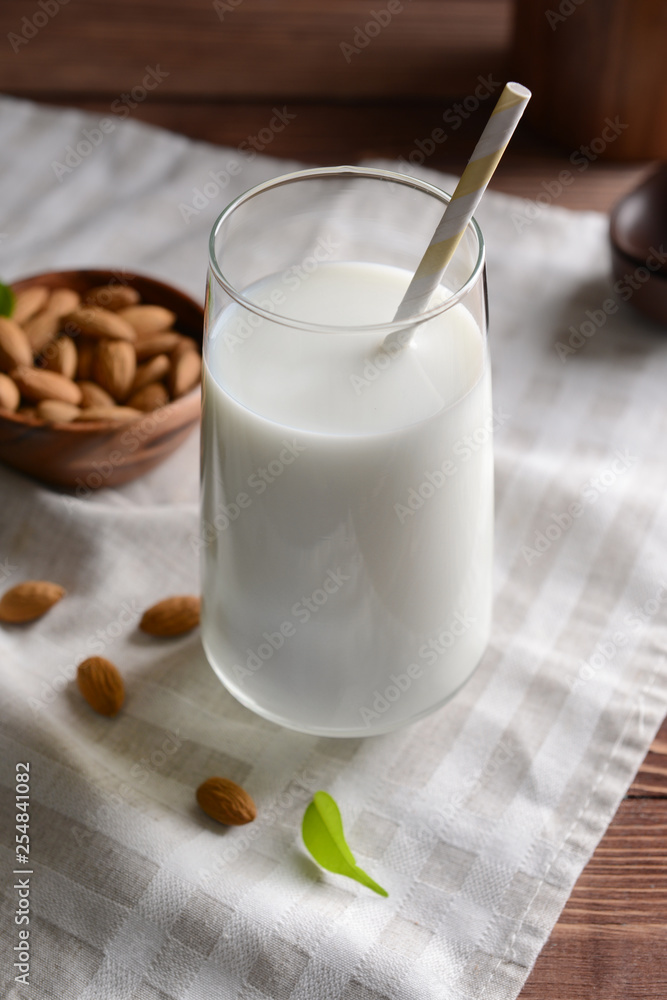 Glass of healthy almond milk on table