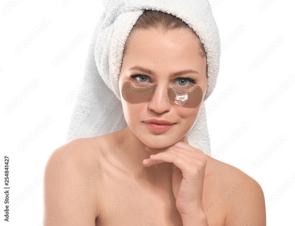 Young woman with under-eye patches on white background