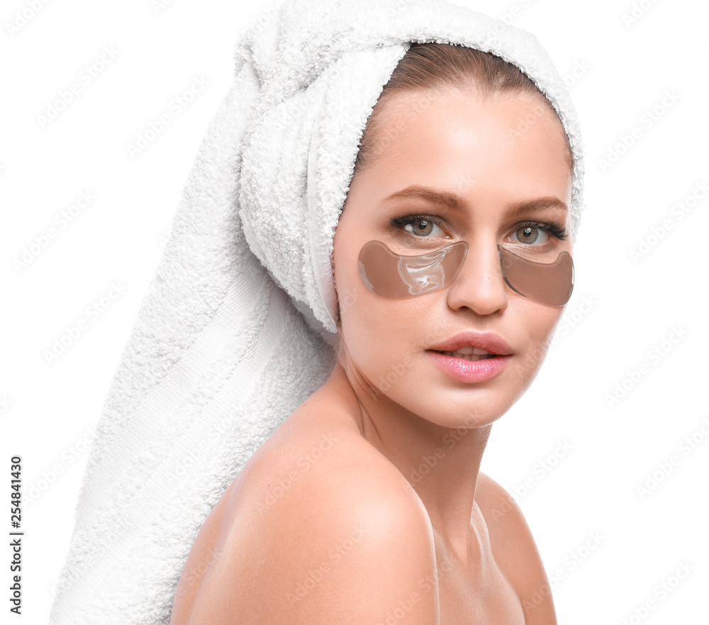 Young woman with under-eye patches on white background