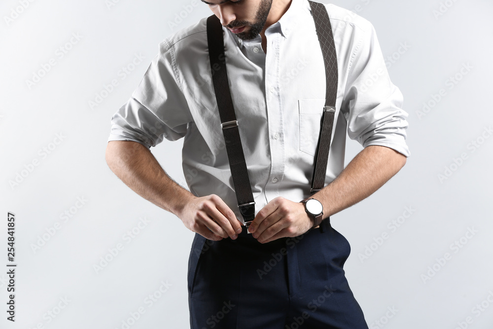 Fashionable young man on light background