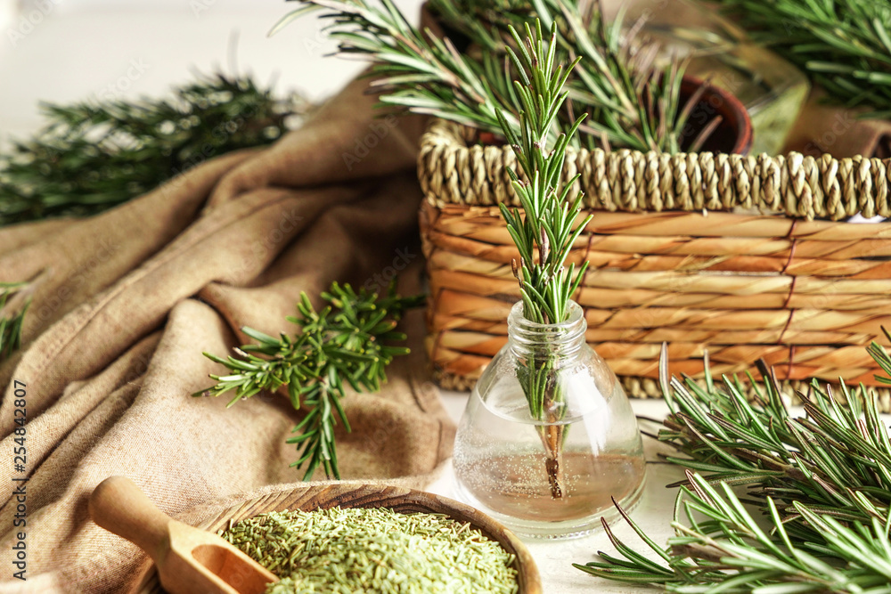 Fresh and dry rosemary on table