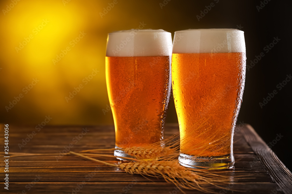 Glasses of fresh beer on table