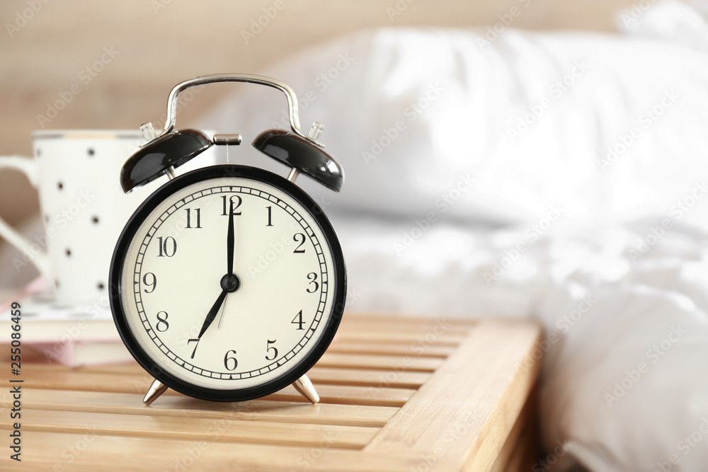 Alarm clock on table in bedroom