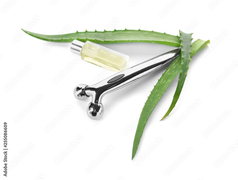 Facial massage tool with essential oil on white background