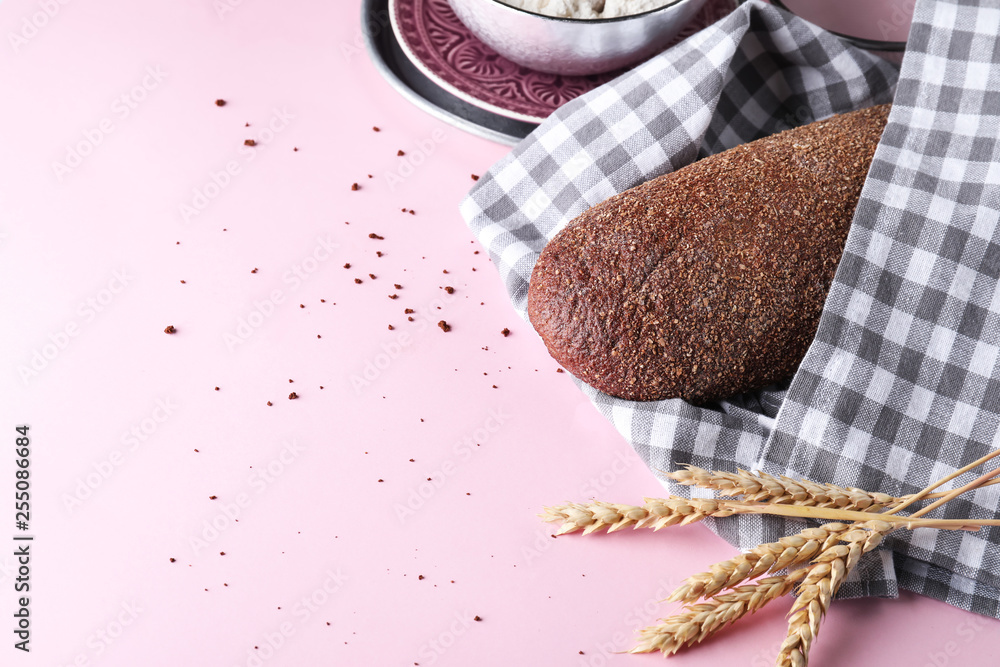 Loaf of tasty bread on color background