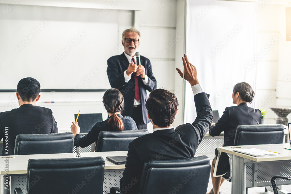 Senior leader speaker speaks to public people audience in training workshop or conference. Mature le