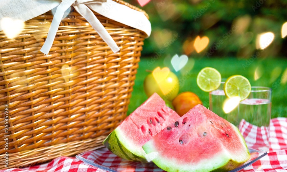 Picnic basket with watermelon on nature