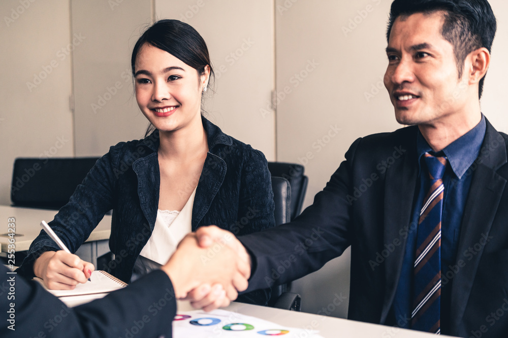 Business people agreement concept. Asian Businessman do handshake with another businessman in the of