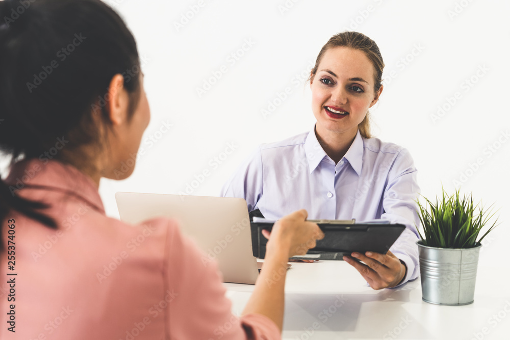 Two young business women in meeting at office table for job application and business agreement. Recr