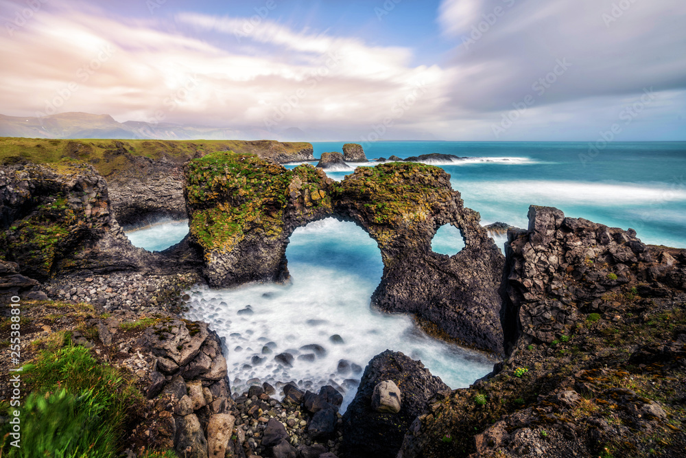 Amazing stone arch Gatklettur basalt rock on Atlantic coast of Arnarstapi in Iceland. The famous nat