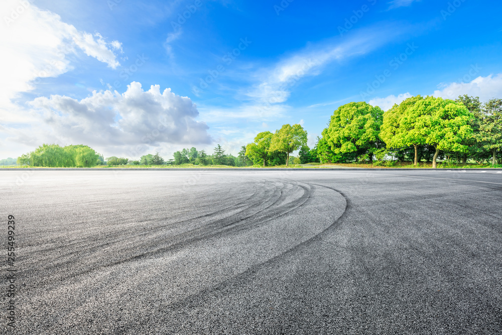 Asphalt race track ground and green woods in the countryside nature park