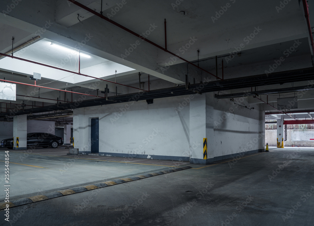 old parking lot with lighting, concrete building