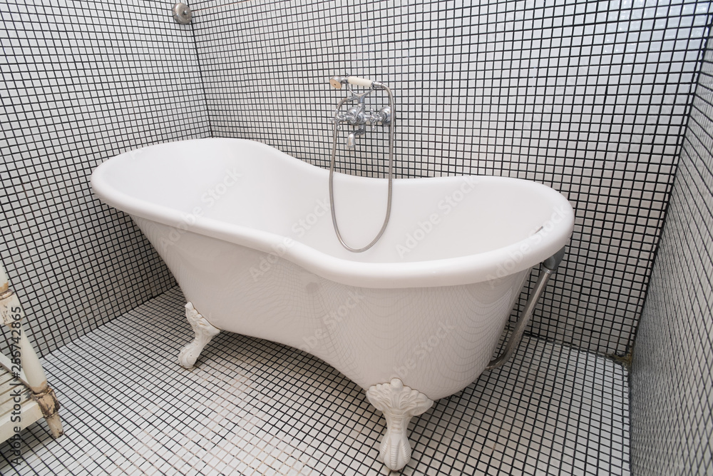 Vintage shower bath tub in colonial interior style bathroom