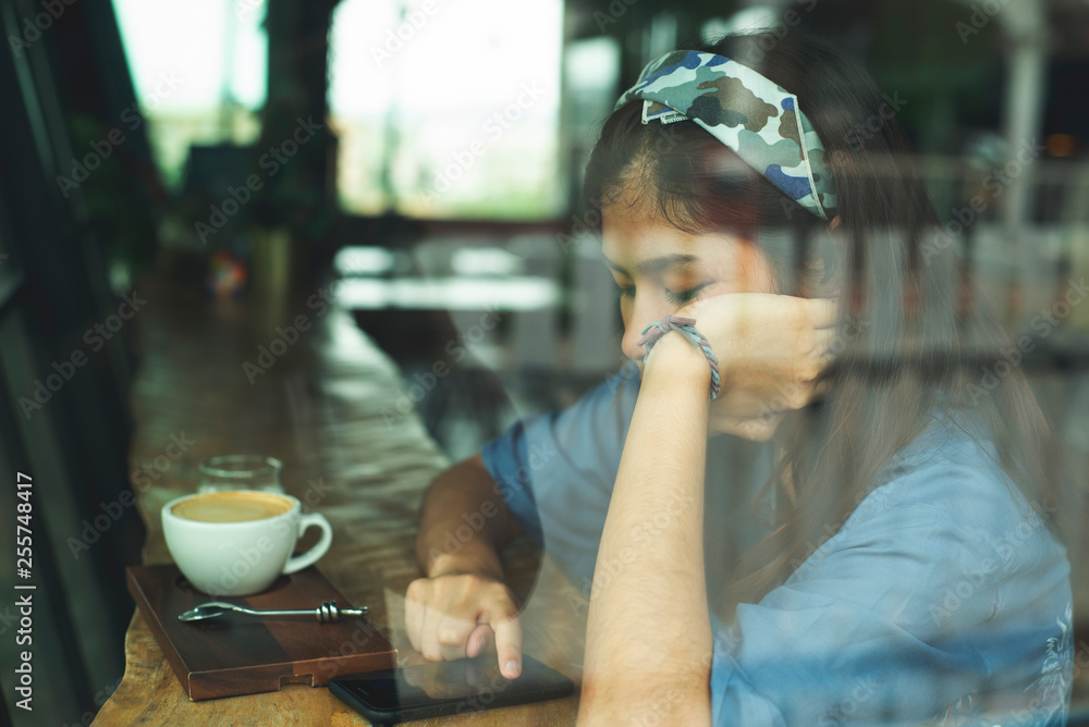 Asia girl feeling sad  with smartphone in hands waiting for call