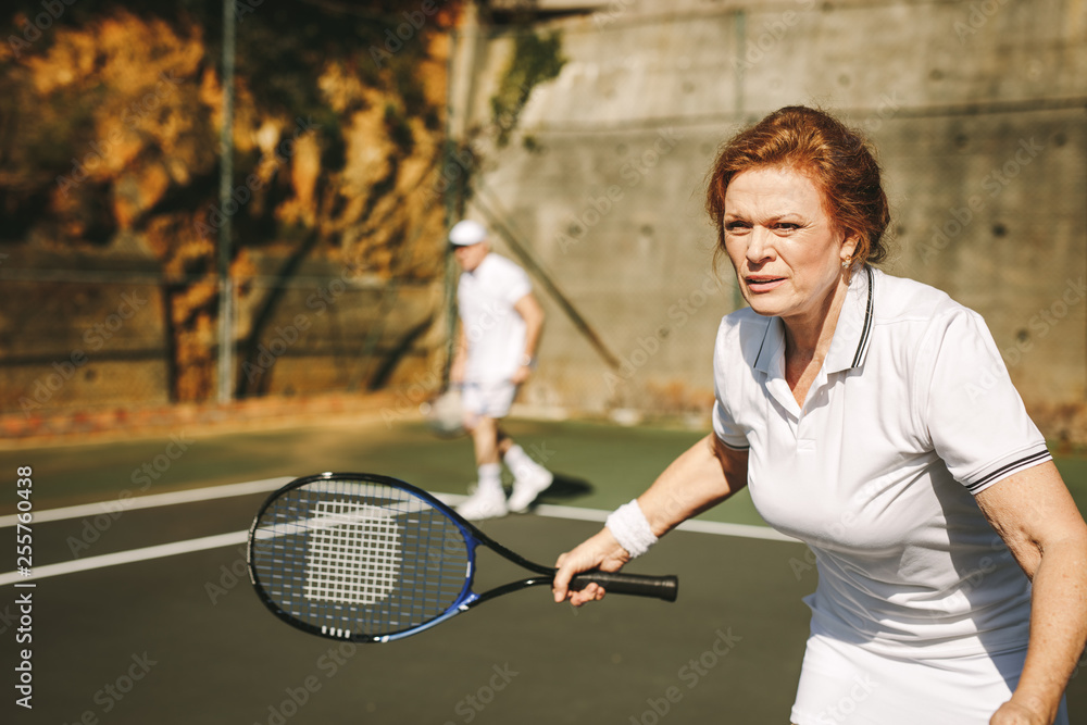 Senior woman playing tennis