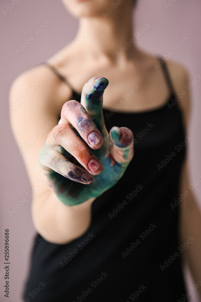 Young woman with painted hand, closeup